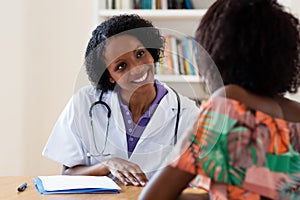 Laughing african american female doctor with patient