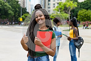 Laughing african american female student with amazing hairstyle