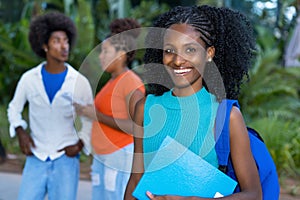 Laughing african american female student with group of black young adults