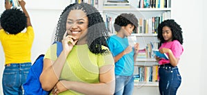 Laughing african american female student with group of college students