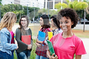 Laughing african american female student with group of international students