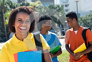 Laughing african american female student with group of other stu