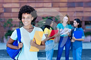 Laughing african american female student with group of students