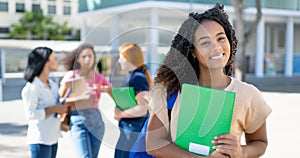 Laughing african american female student with group of young adults