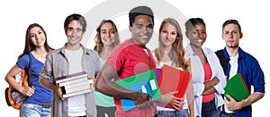 Laughing african american male student with group of students