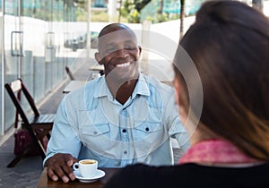 Laughing african american man flirting with caucasian woman