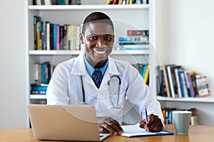 Laughing african american mature male doctor