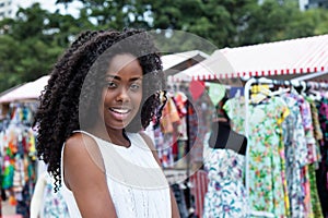 Laughing african american woman shopping at market