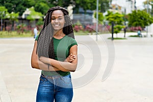 Laughing african american young adult woman with amazing hairstyle photo