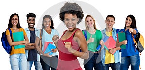 Laughing african american young adult woman with large group of international students