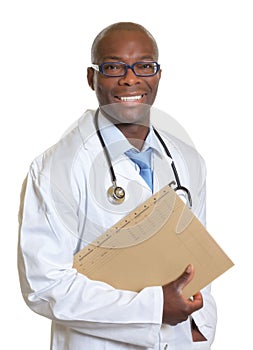 Laughing african doctor with a medical record in his hand