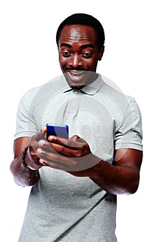 Laughing african man using smartphone