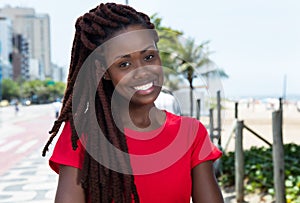 Laughing african woman with dreadlocks in the city