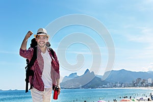 Laughing american hipster tourist at Ipanema beach at Rio de Janeiro