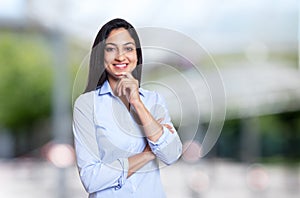 Laughing arabic businesswoman looking at camera