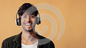 Laughing arabic guy enjoying brand new wireless headset