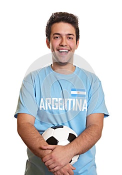 Laughing argentinian soccer fan with ball