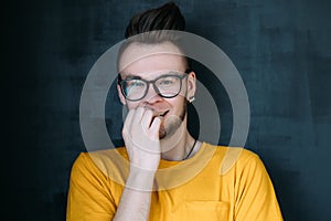 Laughing ashamed emotional hipster guy portrait