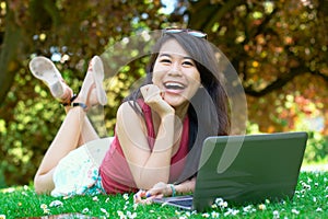 Laughing asian girl at the park