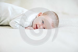 Laughing baby on bed