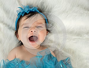 Laughing baby in blue headband