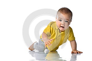 Laughing baby boy crawling over white