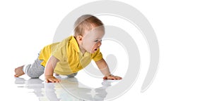 Laughing baby boy crawling over white