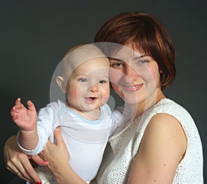 Laughing baby boy and his mother