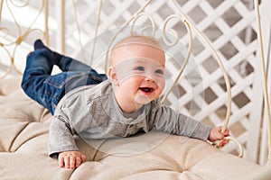 Laughing Baby Boy Lying On Tummy At Home