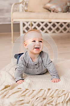 Laughing Baby Boy Lying On Tummy At Home