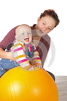 Laughing baby doing exercises