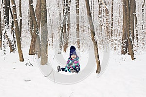 Laughing baby girl lying in the snow