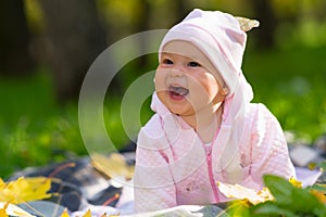 Laughing baby girl with a wide beaming smile.