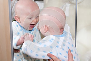 Laughing Baby Looking in Mirror