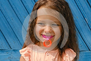 Laughing baby with mouthguard in mouth for bite alignment