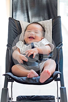 Laughing baby in a perambulator