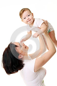 Laughing baby playing with mother