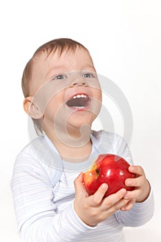 Laughing baby with red apple