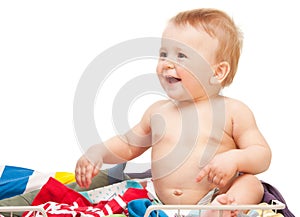 Laughing baby sitting in clothes