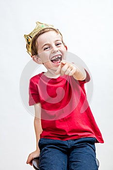 Laughing beautiful spoiled child for mocking attitude and mischievous education photo