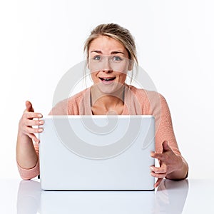 Laughing beautiful young blond business woman holding her laptop