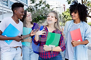 Laughing blond female student with group of internternational students