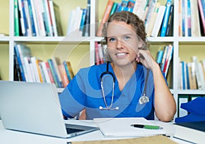Laughing blond medical student at work