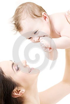 Laughing blue-eyed baby playing with mom