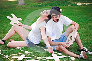 Laughing boy and girl playing tic-tac-toe in the park.