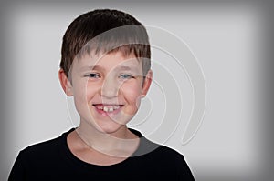 laughing boy on a gray background
