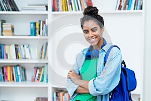 Laughing brazilian female student with backpack