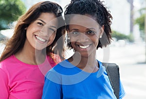 Laughing brazilian girl with caucasian woman