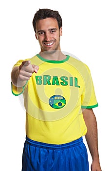 Laughing brazilian soccer fan pointing at camera