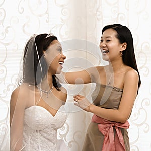Laughing bride and bridesmaid.
